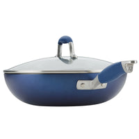 The 12-Inch Ultimate Stir Fry Pan from Advanced Home highlights a sleek stainless steel handle with a coordinating blue rubber grip. This hard-anodized nonstick pan comes with a clear glass lid featuring a blue handle, all beautifully presented against a pristine white background.