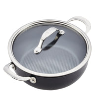 The Anolon X 4-Quart Hybrid Nonstick Casserole Pan features a black body with a grid-patterned nonstick interior, two metal handles, and a transparent glass lid with the brand name on its metal handle. Its ultra-durable design makes it an excellent choice for all braising needs.