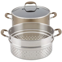 Introducing the Advanced Home 8.5-Quart Wide Stockpot with Multi-Function Insert: a stackable nonstick cookware set that includes a stockpot with a transparent lid and features a stainless steel steamer insert with multiple perforations for efficient steaming. The set is elegantly designed with tan plastic handles.