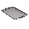 Introducing the Advanced Cookie Sheet with Silicone Grips, a non-stick rectangular baking sheet featuring raised edges and black silicone grips at both ends for easy handling. Designed to ensure even heat distribution, this high-quality metal sheet is perfect for all your baking and roasting needs, beautifully showcased against a pristine white background.