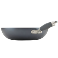 A side view of the black Advanced Home 12-Inch Stir Fry pan highlights its sleek design against a white background. The gray handle, enhanced with a metallic base, perfectly complements its durable hard-anodized construction, making it ideal for your culinary creations.
