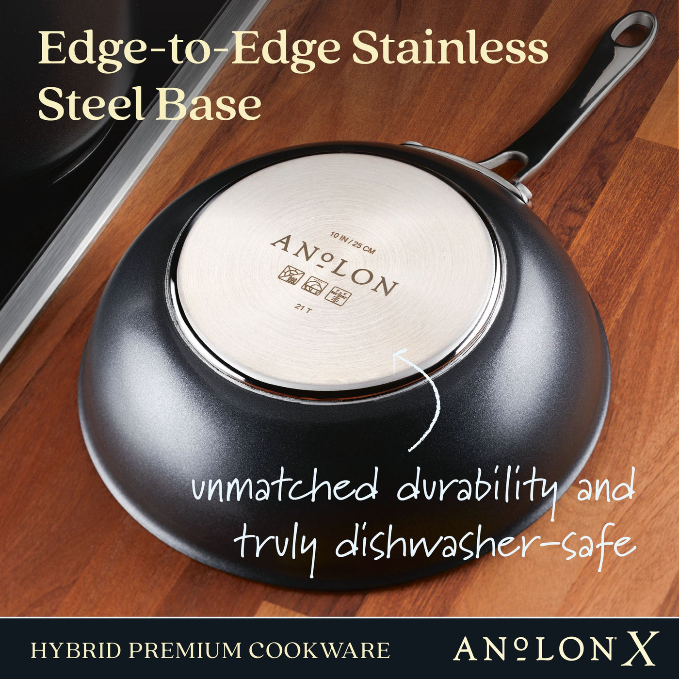 A 10-Inch Hybrid Nonstick Wok With Lid by Anolon X is shown upside down on a wooden surface. The text reads Edge-to-Edge Stainless Steel Base, unmatched durability and metal utensil safe, and Hybrid Premium Cookware.