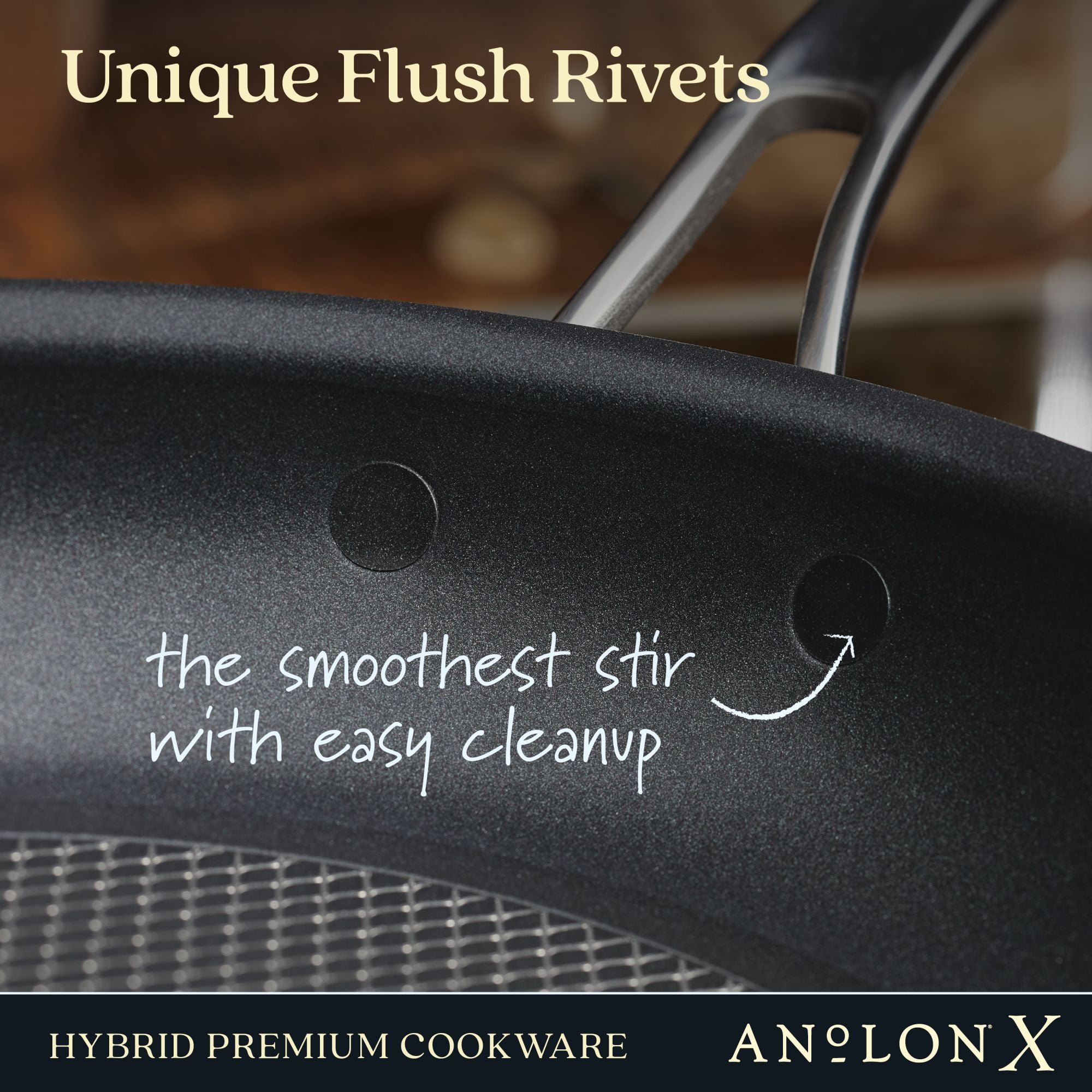 Close-up of the Anolon X 12-Inch Hybrid Nonstick Frying Pan featuring smooth, flush rivets and SearTech™ technology for effortless stirring and easy cleanup. Ultra-durable nonstick is metal utensil safe. Branding: Anolon X Hybrid Premium Cookware.