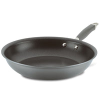 An Advanced Home Frying Pan, featuring a black Infinity Slide nonstick surface and a gray handle, is angled gracefully on a white background.