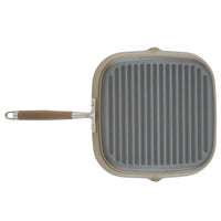 Introducing the Advanced Home 11-Inch Deep Square Grill Pan: this nonstick grill pan features a ribbed cooking surface and a long handle. It comes in an elegant gray finish with beige accents, perfect for stovetop use.