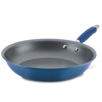 The Advanced Home Frying Pan is shown on a white background. Its sleek, gray interior pairs beautifully with the blue design, and the handle includes a matching grip along with a convenient metal loop for hanging.