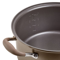 Close-up of a hard-anodized non-stick pot with quart and liter measurement markings inside, ranging from 1 to 4. Part of the Advanced Home Round Two Step Meal Set, it boasts a brown handle and metallic finish, offering practicality akin to a 5-quart Dutch oven.