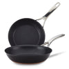 The Nouvelle Luxe 8.5 & 10-Inch Frying Pan Set features black nonstick pans with silver handles, displayed nested on a white background. These induction-compatible pans are also dishwasher safe for easy cleaning.