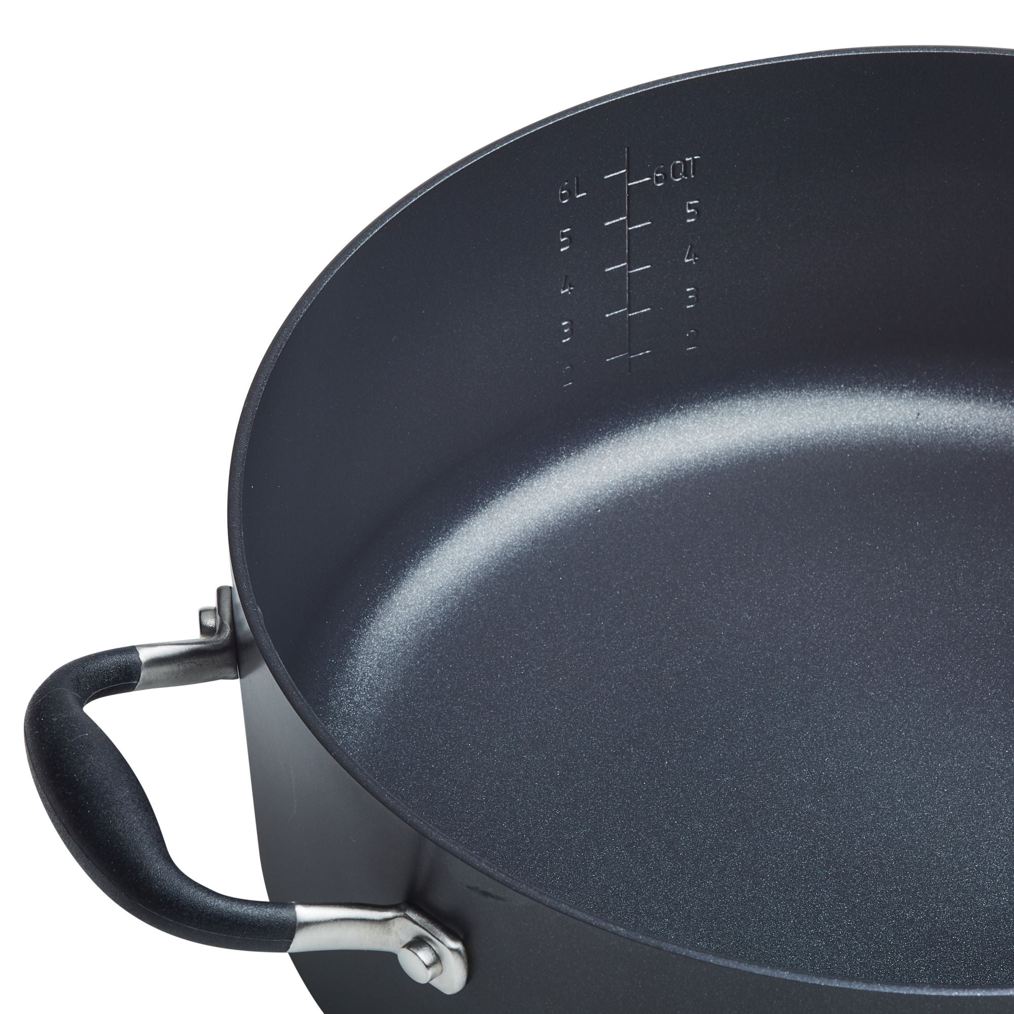 The 7.5-Quart Stockpot by Advanced Home is a close-up view of a spacious nonstick black cooking pot with marked measurements in liters and quarts inside. It features a metal handle with a black grip, providing excellent heat distribution for even cooking.