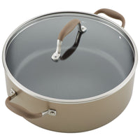 The 7.5-Quart Stockpot from Advanced Home is a large, round, nonstick wide pot with a glass lid. It features two brown rubber handles on each side for easy handling and comes in metallic gray to ensure superior heat distribution. The lid also has a metallic handle with the same brown rubber grip for added convenience.