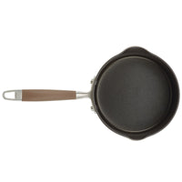 Presenting the 2-Quart Straining Saucepan by Advanced Home: This top-view image showcases a compact, black, nonstick saucepan with hard-anodized durability. It features a brown handle fastened with rivets and ending in a metal loop for easy storage. The saucepan includes two small spouts on opposite sides, perfect for straining and pouring efficiently.
