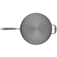 Top view of Advanced Home's 5-Quart Sauté Pan with Helper Handle, showcasing its gray non-stick surface. The pan is highlighted by its circular brushed finish and features a main handle and a helper handle. It sits against a white background, and the sleek design is complemented by a glass lid that enhances both functionality and style.