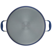 Top view of an Advanced Home 7.5-Quart Stockpot lid with blue handles, designed for optimal heat distribution. The circular lid features a brushed stainless steel finish and a central embossed logo, with the handles elegantly attached on opposite sides, perfectly complementing your wide stockpot.