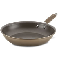 The Advanced Home Frying Pan boasts a brown exterior and gray interior, complemented by a long handle securely attached with two rivets. This stylish and functional nonstick skillet is showcased against a simple white background.