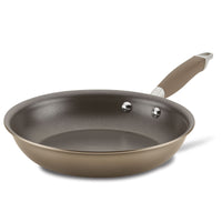 The Frying Pan from Advanced Home boasts a chic dark interior complemented by a warm brown exterior. Its elongated, ergonomic handle, attached with two rivets, is subtly darker than the pan's body. Beautifully displayed against a white backdrop, it offers straightforward cooking and simple maintenance.