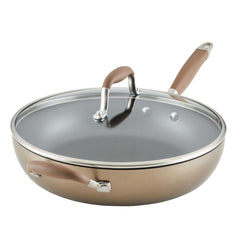 Introducing the Advanced 12-Inch Deep Frying Pan, a durable cooking essential with a nonstick surface and glass lid. Featuring brown handles for easy grip, this metallic skillet is engineered with a wide base and slightly angled sides for optimal cooking performance. The matching handle on the lid allows for effortless handling, making it a must-have piece of cookware in any kitchen.