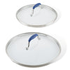 Two lids from the Advanced Home Lid Set, featuring glass with stainless steel edges and SureGrip® blue handles, are displayed. The replacement lids vary in size, with the smaller resting on top of the larger one. Both are shown from above against a plain white background.