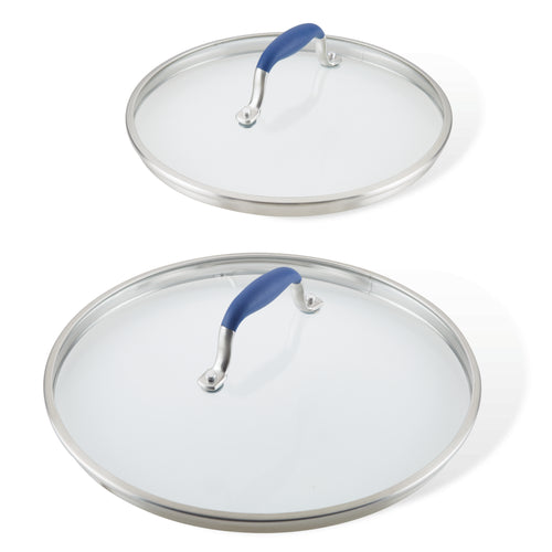 Two lids from the Advanced Home Lid Set, featuring glass with stainless steel edges and SureGrip® blue handles, are displayed. The replacement lids vary in size, with the smaller resting on top of the larger one. Both are shown from above against a plain white background.