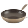 The Advanced Home 12-Inch Stir Fry pan features a deep-dish design with a brown exterior and black interior. Its handle, which includes a silver end, is securely attached using two metal rivets. With Hard-Anodized construction and Infinity Slide nonstick technology, this pan delivers outstanding performance at a slight angle.