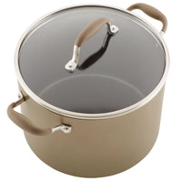 Introducing the 10-Quart Stockpot by Advanced Home: a spacious brown cookware piece designed with a glass lid and two sturdy handles. The handles feature beige, non-slip grips for safety and convenience. This wide stockpot ensures excellent heat distribution and is crafted specifically for stovetop use with a sleek design.