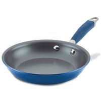 The Advanced Home Frying Pan features a blue Infinity Slide nonstick coating with a metallic interior and a handle designed with a hole for hanging. The pan is angled to highlight its smooth surface and robust construction.