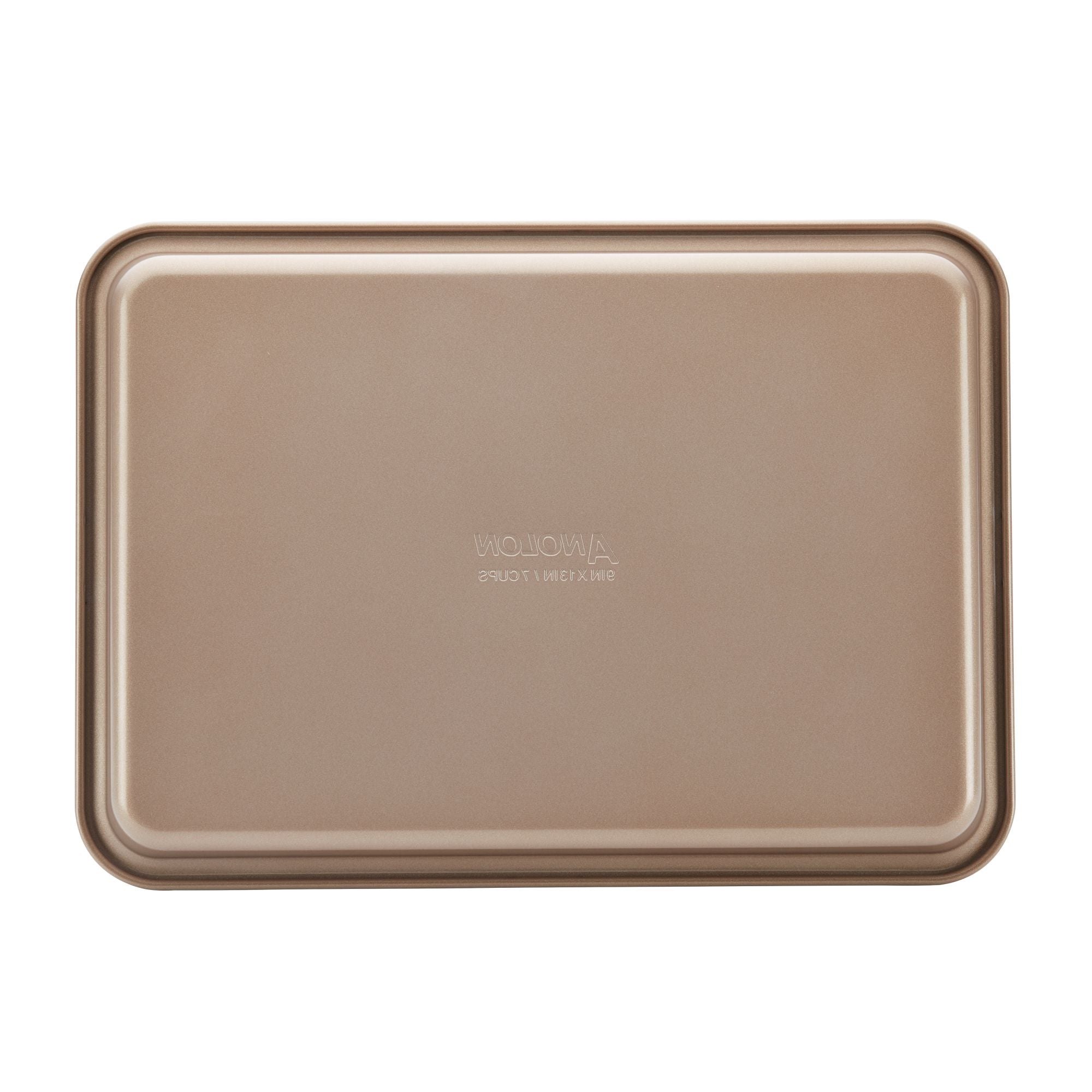 Part of the 3-Piece Gourmet Cookie Pan Set by Gourmet, this beige rectangular metal baking tray boasts a smooth nonstick surface ideal for homemade cookies. It features a raised lip around its edges and is presented against a plain white background.