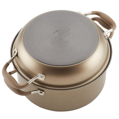 A gold, nonstick 5-quart Dutch oven from the Round Two Step Meal Set is shown with its lid placed upside down. The handles are rubberized and brown, and the base features the brand name Advanced Home, known for its hard-anodized cookware.