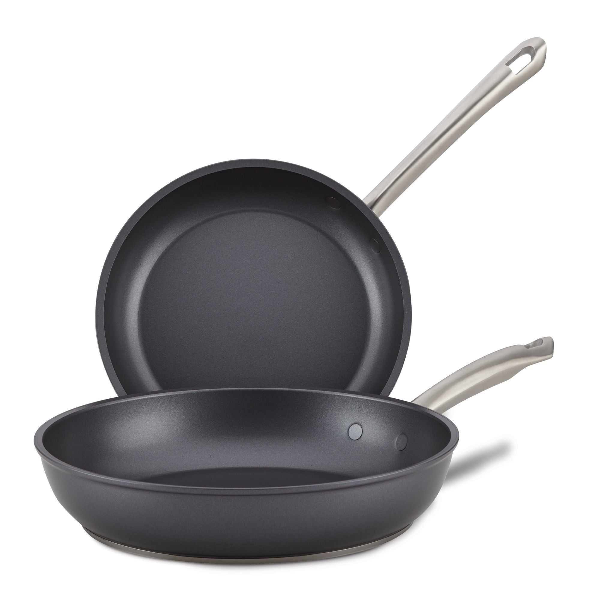The Accolade 8 & 10-Inch Frying Pan Set features two precision-forged pans with metallic handles and smooth, sapphire-reinforced dark interiors, one lying flat and the other propped upright behind it.