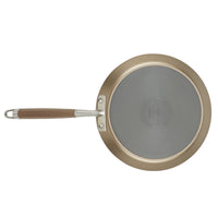 From an overhead perspective, the Advanced Home 9.5-Inch Crepe Pan features a circular non-stick surface with a central seal and text. This gray cooking area is complemented by a beige handle, secured with rivets and equipped with a metal loop at the end for convenient use.