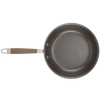 An essential piece from the Advanced Home 11-Piece Cookware Set, crafted from hard anodized aluminum and featuring a brown handle with metal rivets and a hanging hole, is viewed from above. This non-stick frying pan showcases a smooth, dark interior surface.