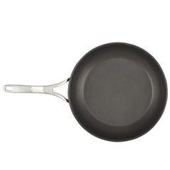 The durable and hard-anodized frying pan from the Nouvelle Luxe 11-Piece Cookware Set showcases the Infinity Slide™ Nonstick System. From above, its sleek, dark cooking surface elegantly contrasts with the polished metal handle, which includes a hole at the end for convenient hanging, blending style with practicality.