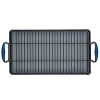 An Advanced Home 10 x 18-Inch Double Burner Griddle with a multi-purpose rack and two blue SureGrip handles is seen from above against a white background.