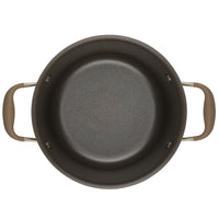 A top view of the Advanced Home 4.5-Quart Tapered Saucepot, featuring a nonstick round design with dark-colored exteriors and brown handles on each side. Its smooth interior surface is perfect for gourmet sauce-making and expertly crafted for stovetop cooking.