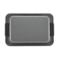 The Advanced 9 x 13-Inch Cake Pan with Lid is a rectangular nonstick bake pan, featuring raised edges and black handles on each side, shown from above against a white background.