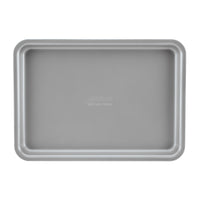 The 3-Piece Gourmet Cookie Pan Set, in an elegant gray tone by Gourmet, is ideal for homemade cookies with its rectangular design featuring raised edges on all sides. Its nonstick surface is showcased from above against a white background.