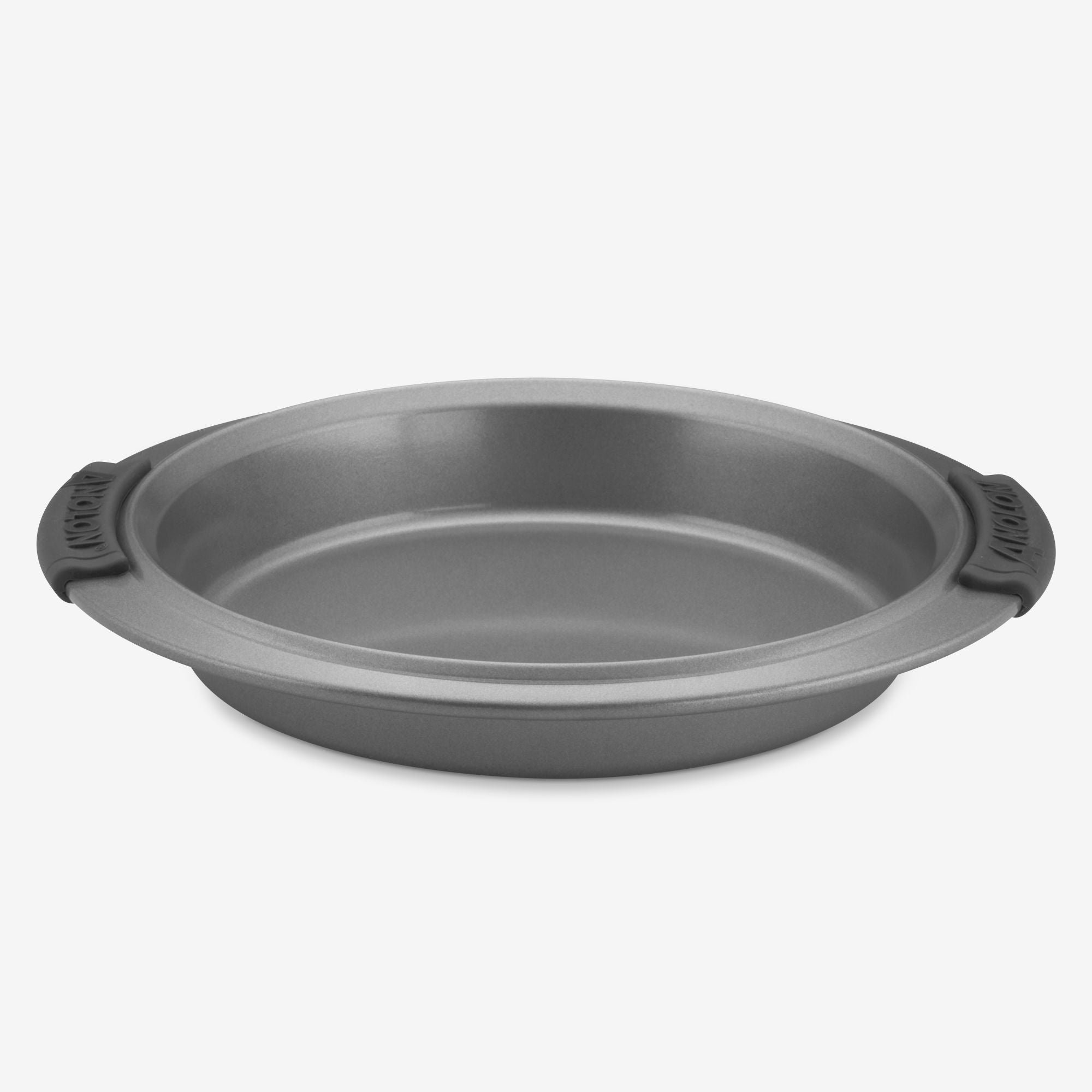 An Advanced 9-Inch Round Cake Pan, crafted from gray metal and featuring a nonstick coating, is elegantly displayed against a plain white background. The pan includes silicone grips on both handles for added convenience.