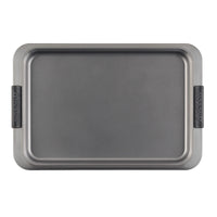 The 5-Piece Bakeware Set by Advanced includes a rectangular gray baking sheet featuring raised edges and black gripped handles on both sides. It's perfect for crafting delicious bar cookies, with its clean metal surface ensuring reliable baking results every time, making it an essential component of any nonstick bakeware collection.