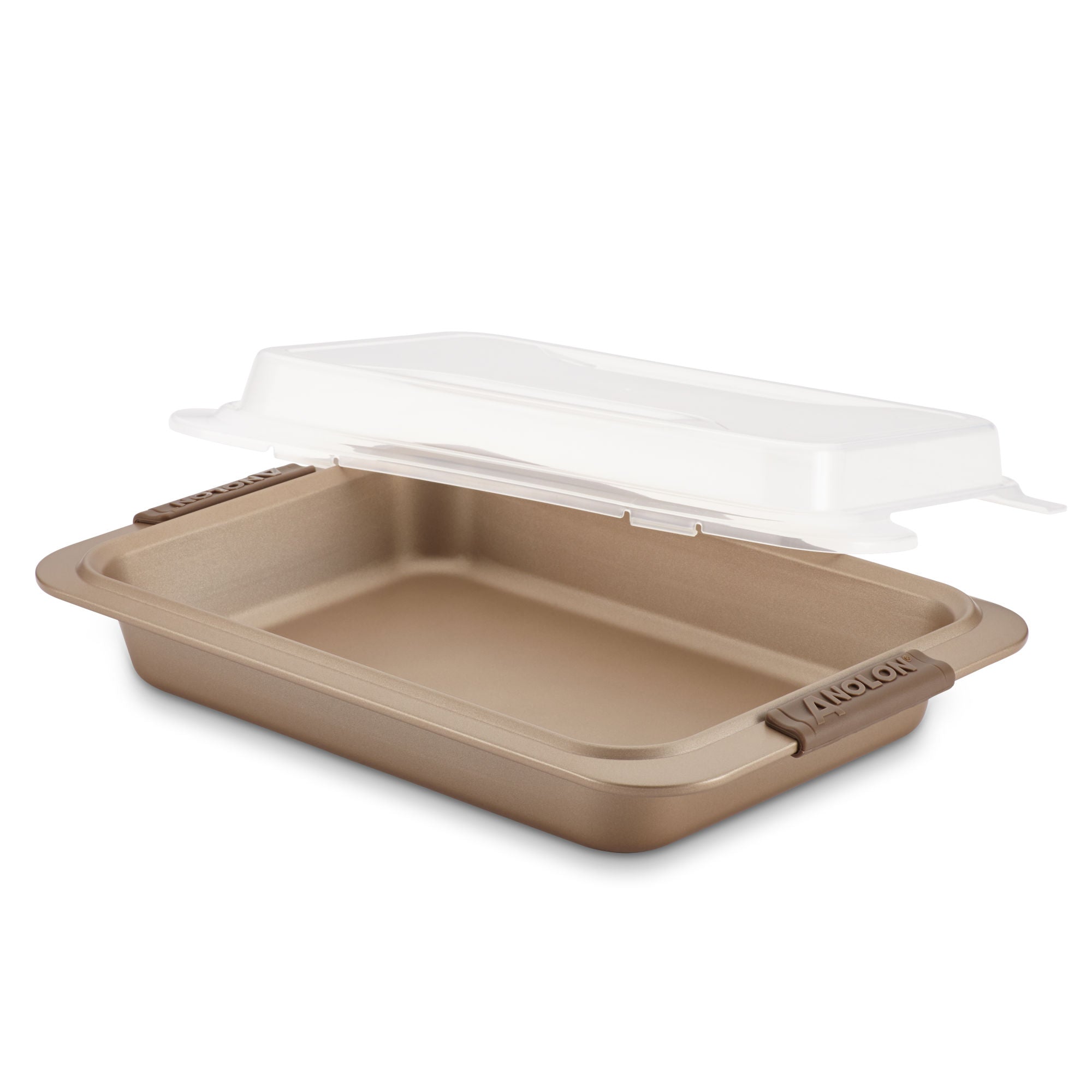 An Advanced 9 x 13-Inch Cake Pan with Lid, featuring a gold finish, handles, and a clear plastic lid, sits ready to be placed on top.