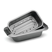 Introducing the 2-Piece Loaf Pan Set by Advanced, featuring two stacked dark gray baking pans from our nonstick bakeware collection. The top pan is designed with holes for draining, similar to a drip pan insert, while the bottom pan remains solid. Both pieces include convenient side handles for easy handling.