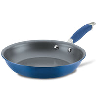 An Advanced Home Frying Pan, showcasing a blue exterior with a silver interior and a matching blue handle complete with a silver hanging loop at the end, is elegantly displayed against a white background.