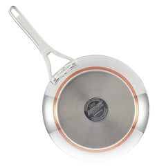 The Nouvelle Stainless 12-Inch Frying Pan with Lid features a long handle and a circular copper core for even heat distribution. This frying pan prominently displays the Nouvelle Stainless brand, emphasizing its superior materials and sleek design.