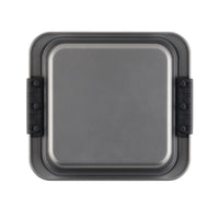 This square cake pan from the Advanced 5-Piece Bakeware Set features a metal construction with black removable sides and a flat base. The visible handles simplify detaching and securing, making it perfect for baking banana nut bread or bar cookies. Its non-stick surface ensures effortless food release every time.