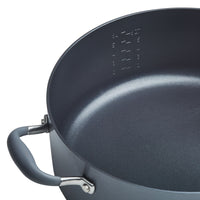 Close-up of a gray Advanced Home 7.5-Quart Stockpot with a measurement scale on the inner side. The pot boasts excellent heat distribution and features a sturdy handle with a metallic connection to the body.